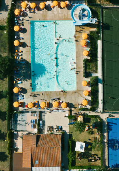 Aerial view of pool, soccer field, and tennis courts.